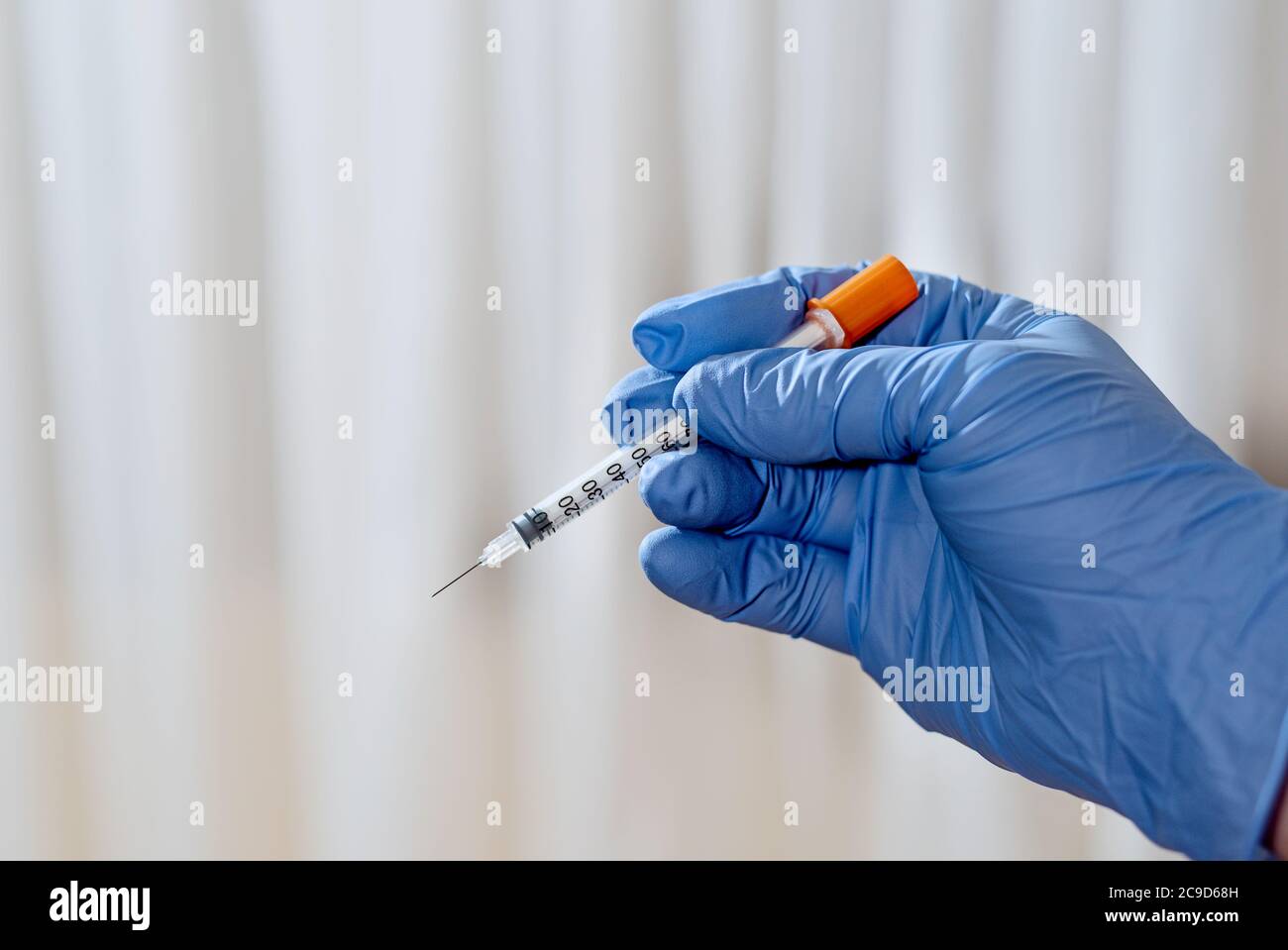 Nurse`s hand with syringe ready to apply Stock Photo